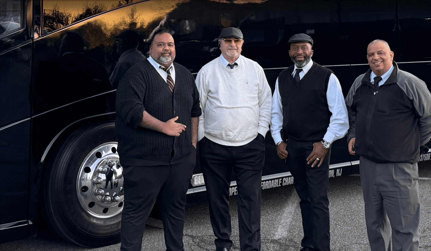 Luxury charter bus with city skyline in background